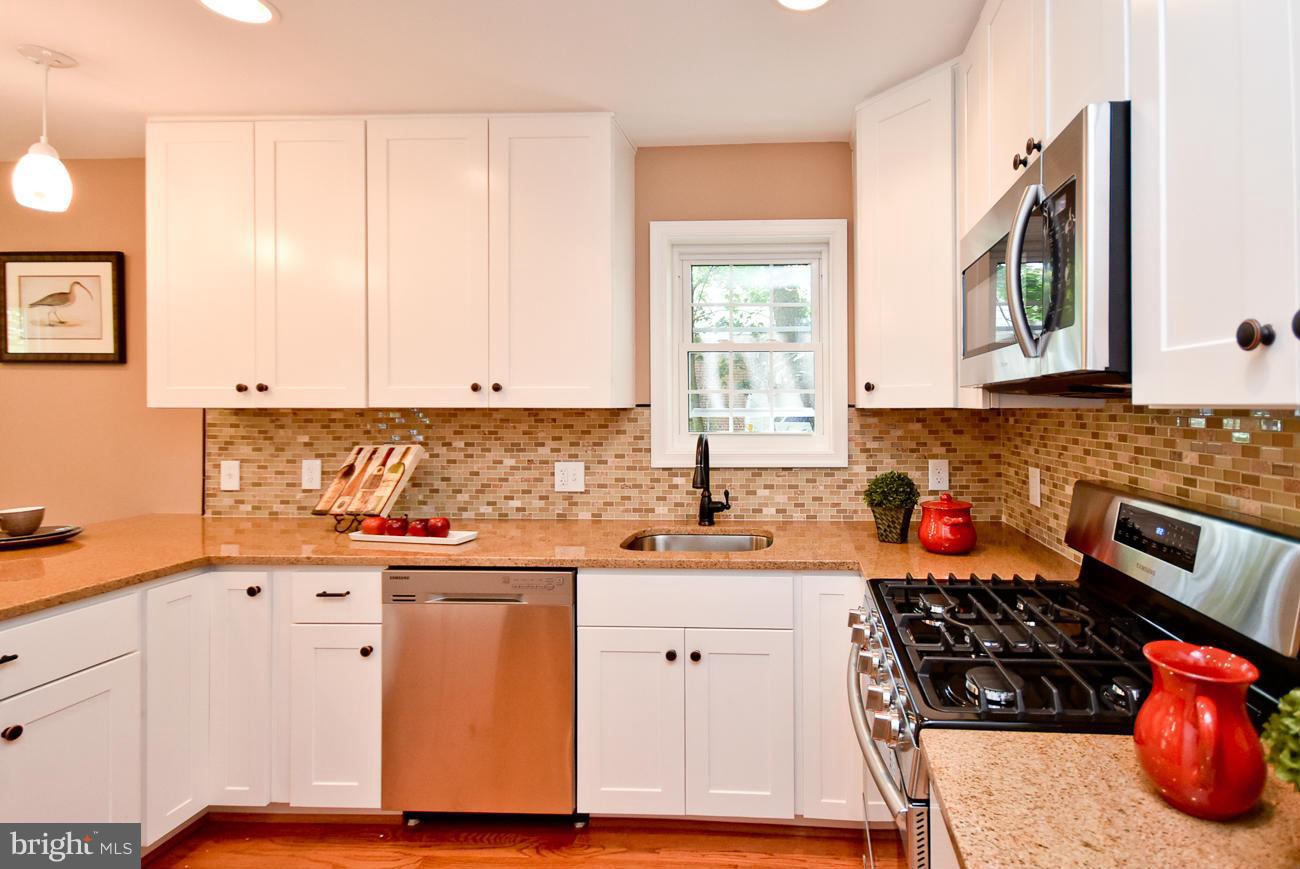 5900 Grayson Street Springfield, VA 22150 - Photo 10 of 30 a kitchen with stainless steel appliances a stove top oven