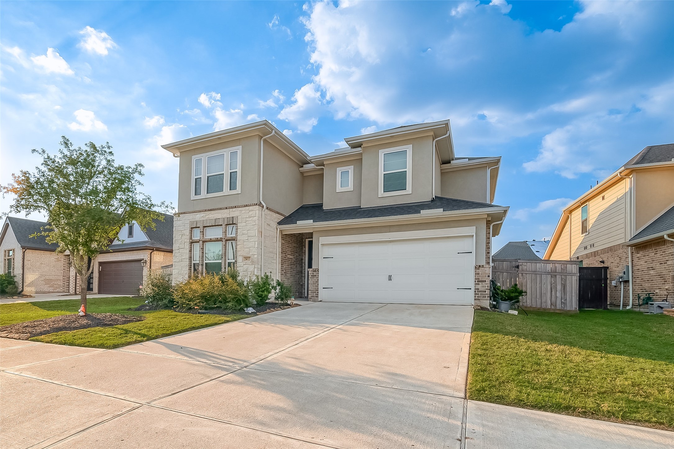 a view of a house with a backyard and a garage