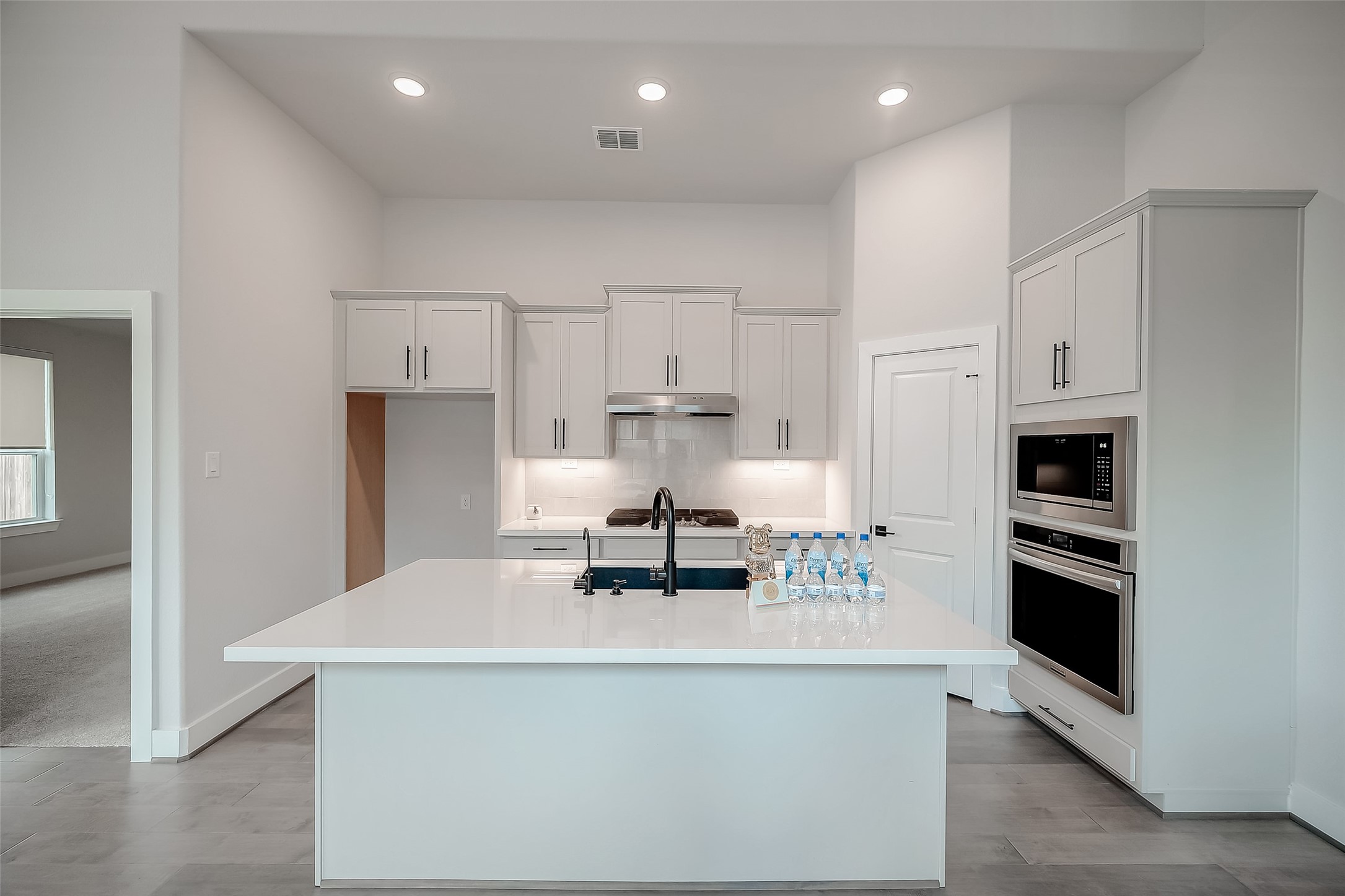 29022 Laurel Grove Lane Fulshear, TX 77441 - Photo 12 of 42 a kitchen with kitchen island a stove and a refrigerator