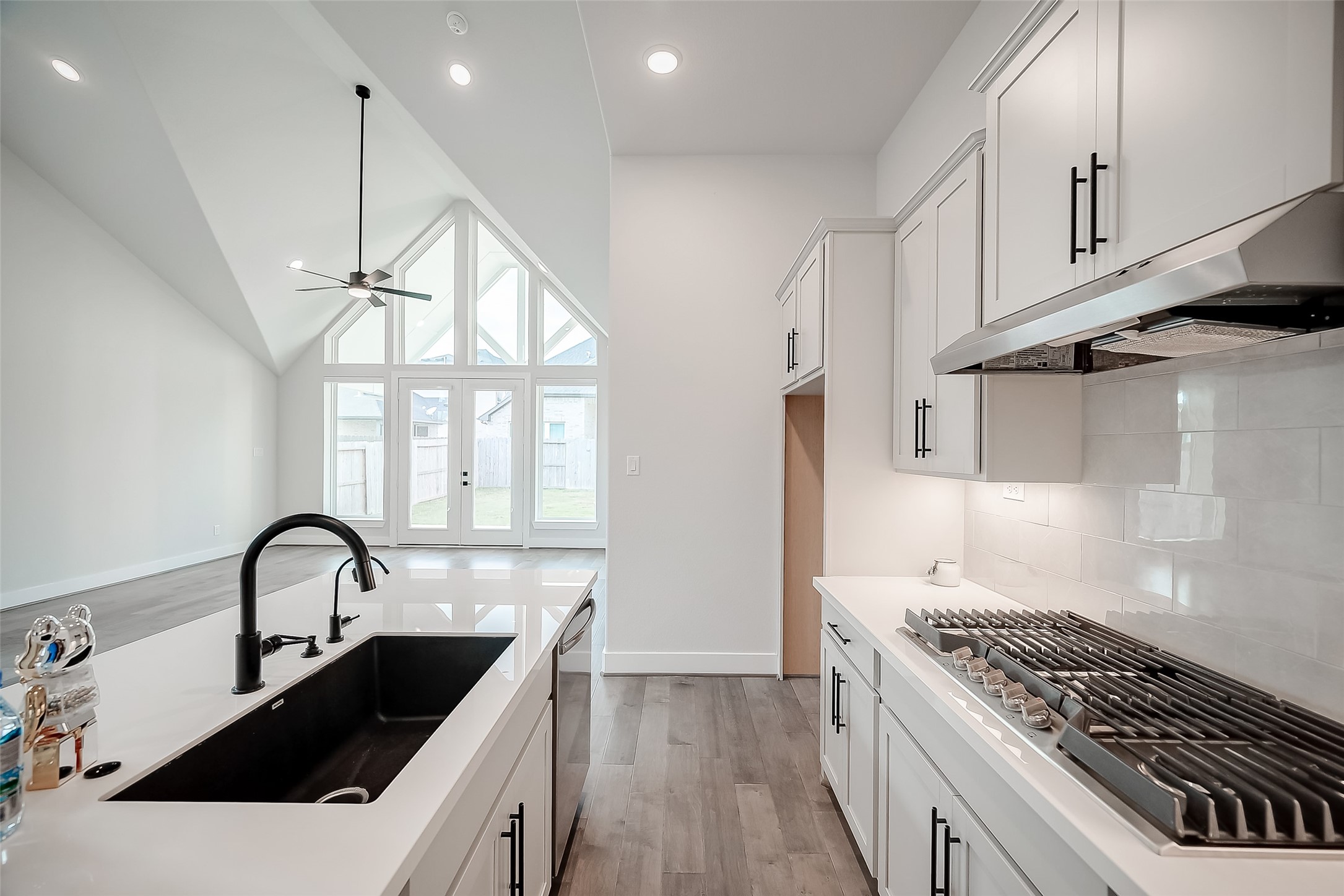 29022 Laurel Grove Lane Fulshear, TX 77441 - Photo 14 of 42 a kitchen with a sink a stove and cabinets
