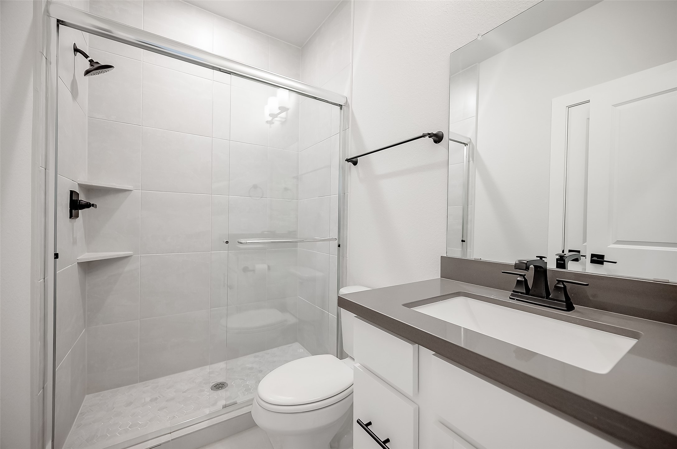 29022 Laurel Grove Lane Fulshear, TX 77441 - Photo 19 of 42 a bathroom with a sink toilet double vanity and shower