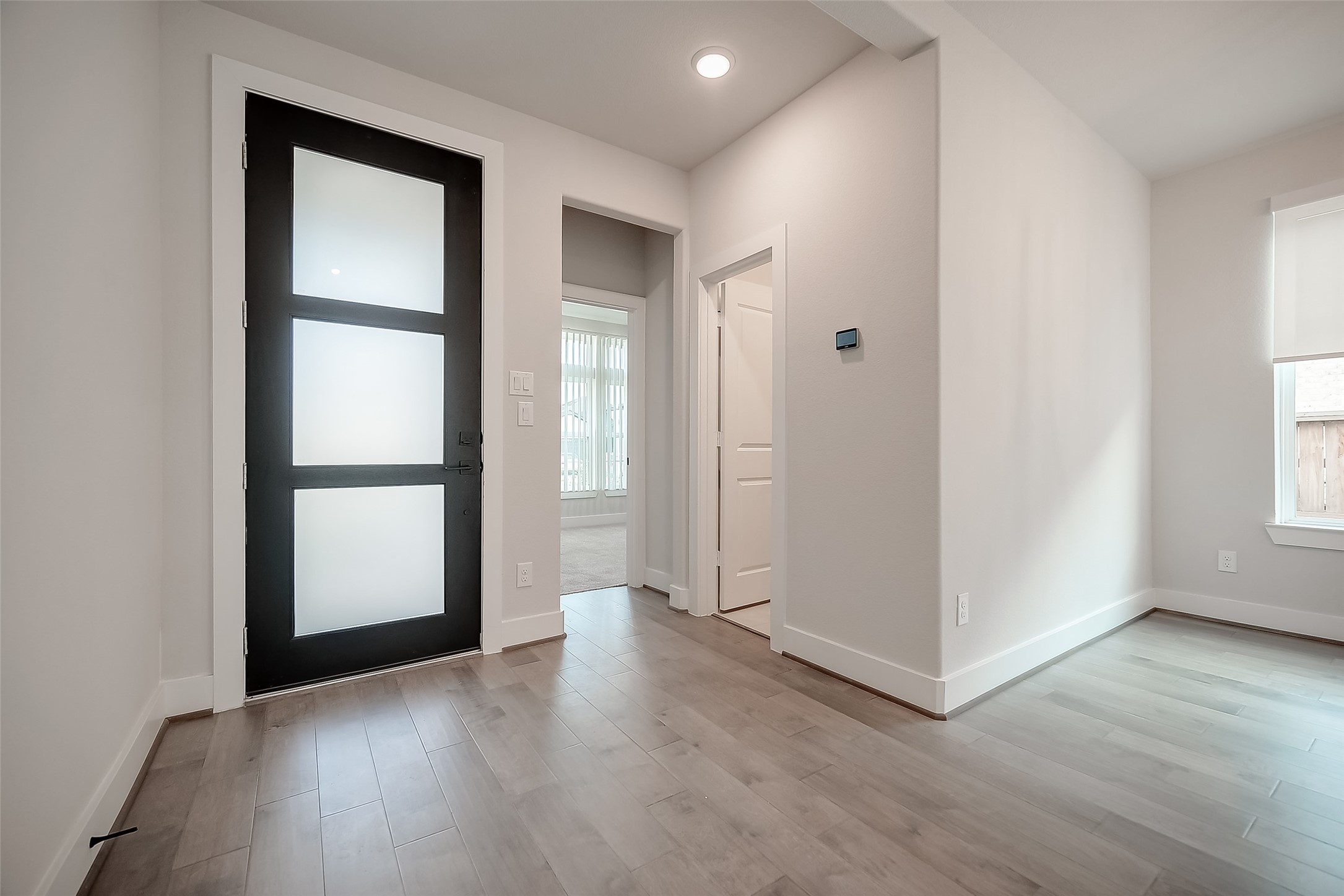29022 Laurel Grove Lane Fulshear, TX 77441 - Photo 3 of 42 an empty room with wooden floor and windows