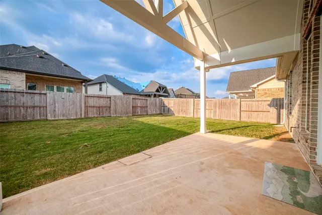 a view of a yard in front of a house with a fountain