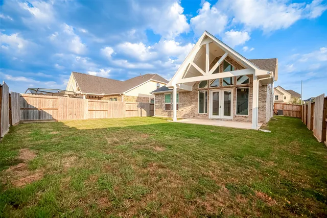 a view of a house with a backyard and a garden