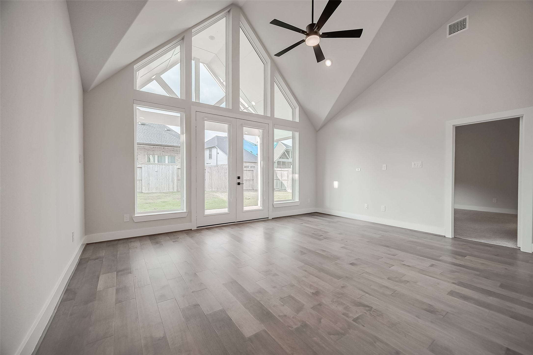29022 Laurel Grove Lane Fulshear, TX 77441 - Photo 9 of 42 a view of an empty room with wooden floor and a window