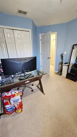 a living room with a pool table and a couch
