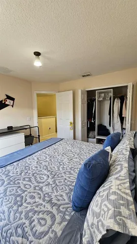 a bedroom with a large bed and a dresser