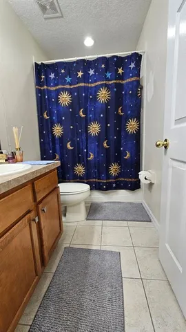 a room with a wooden floor and cabinets