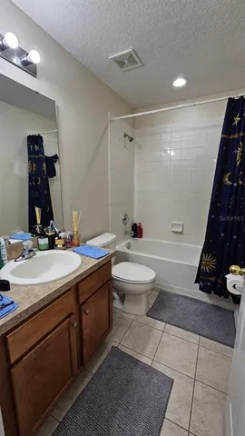 a bathroom with a double vanity sink a toilet and a mirror