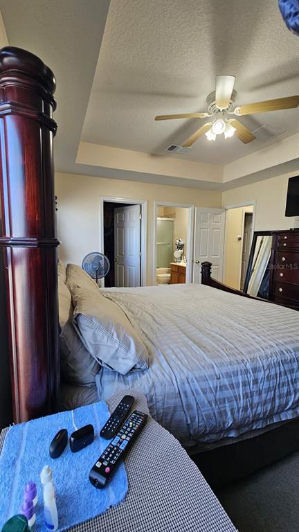 10193 Ridgebloom Avenue Orlando, FL 32829 - Photo 19 of 41 a bedroom with a bed and a mirror