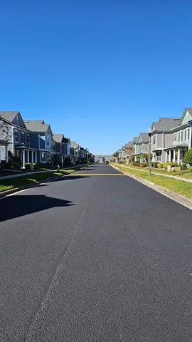 a view of a swimming pool with a table and chairs under an umbrella