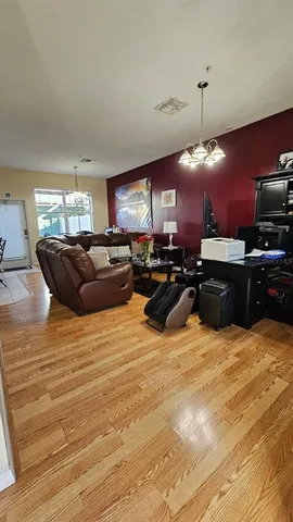 a large room with furniture a chandelier and a flat screen tv