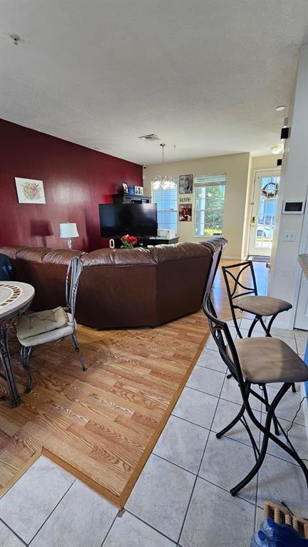 10193 Ridgebloom Avenue Orlando, FL 32829 - Photo 5 of 41 a living room with furniture and a dining table with rug