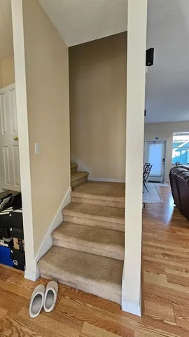 a view of entryway and hall with wooden floor