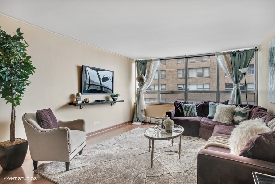 6171 North Sheridan Road, Unit 1204 Chicago, IL 60660 - Photo 2 of 15 a living room with furniture and a flat screen tv