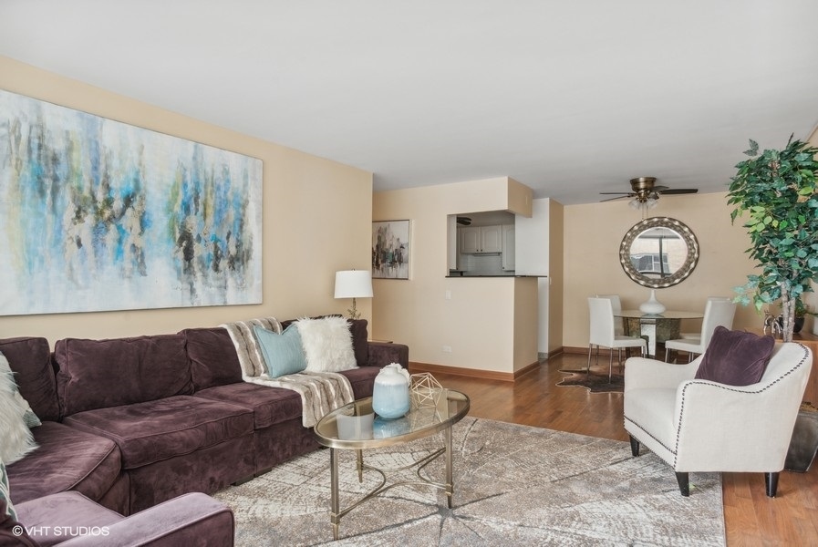 6171 North Sheridan Road, Unit 1204 Chicago, IL 60660 - Photo 3 of 15 a living room with furniture and wooden floor