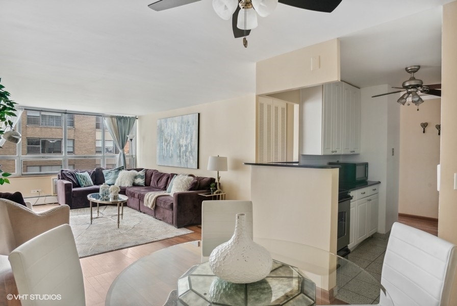 6171 North Sheridan Road, Unit 1204 Chicago, IL 60660 - Photo 5 of 15 a living room with furniture a window and wooden floor