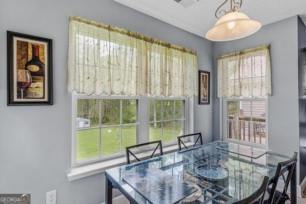 80 Upper Caldwell Road Bowdon, GA 30108 - Photo 9 of 33 a dining room with furniture and window