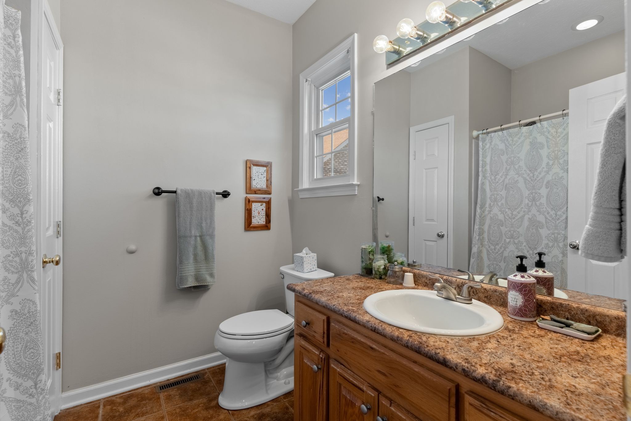3736 Armstrong Road Springfield, TN 37172 - Photo 19 of 60 a bathroom with a granite countertop sink toilet a large mirror and shower