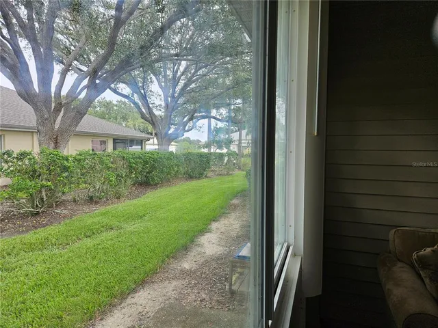 an empty room with a chandelier fan