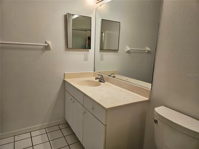 a bathroom with a sink a toilet and shower curtain