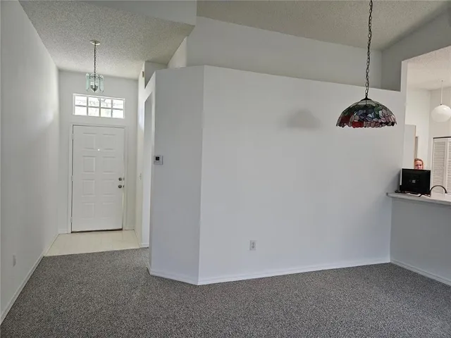 a view of a chandelier fan and a refrigerator in a kitchen