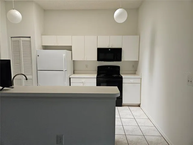 a kitchen with a sink cabinets and appliances