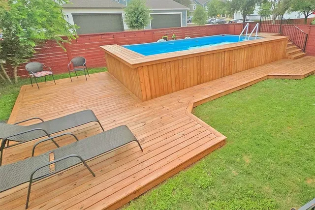 a view of a backyard with a wooden deck