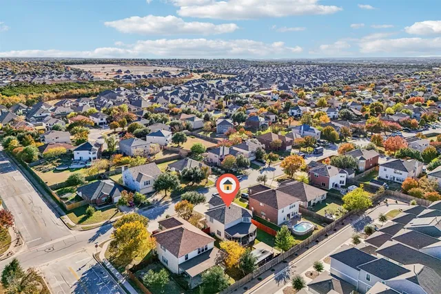 an aerial view of residential houses with outdoor space