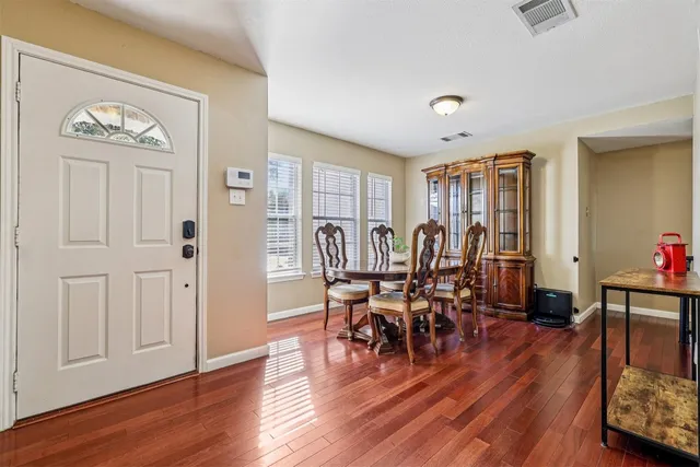 a view of a dining room with furniture and wooden floor