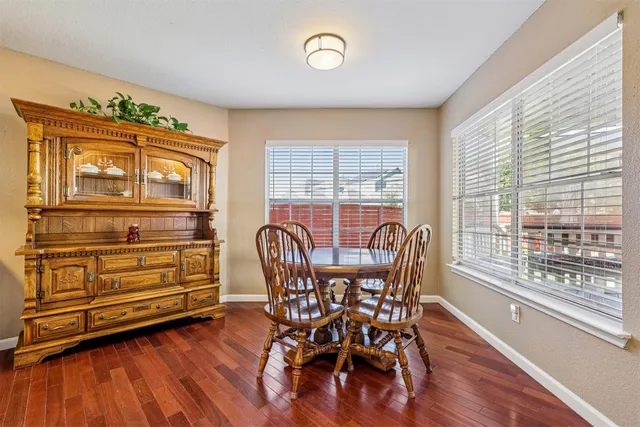 a view of a dining room with furniture window and wooden floor