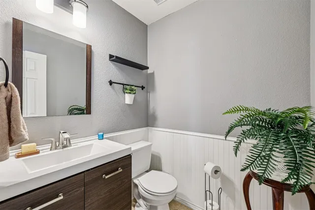 a bathroom with a sink toilet and mirror