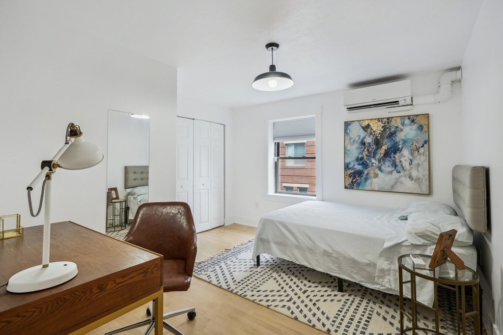 59 Fleet Street, Unit 3 Boston, MA 02109 - Photo 12 of 24 a bedroom with a bed and chandelier