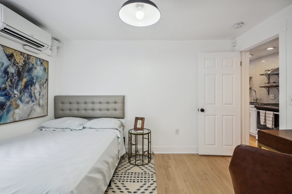 59 Fleet Street, Unit 3 Boston, MA 02109 - Photo 14 of 24 a bedroom with a bed and a painting on the wall