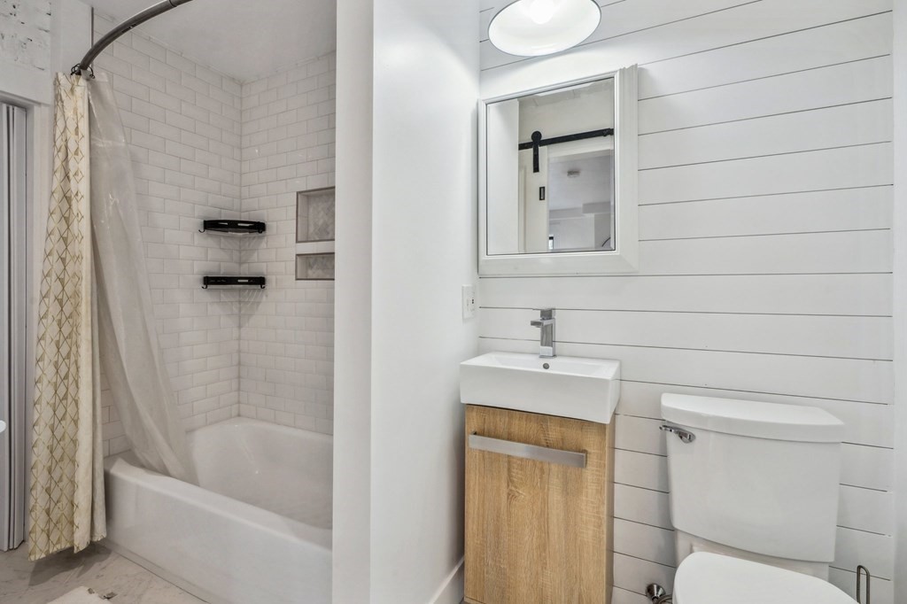59 Fleet Street, Unit 3 Boston, MA 02109 - Photo 19 of 24 a bathroom with a sink a toilet and shower