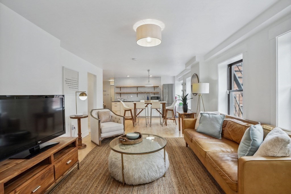 59 Fleet Street, Unit 3 Boston, MA 02109 - Photo 3 of 24 a living room with furniture and a flat screen tv