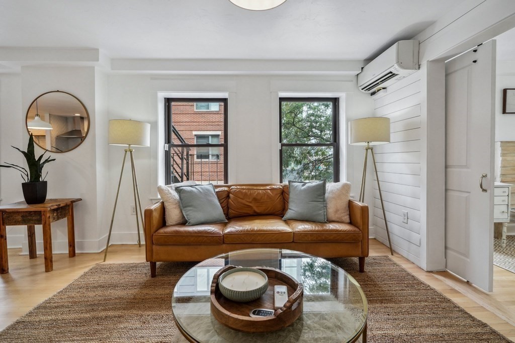 59 Fleet Street, Unit 3 Boston, MA 02109 - Photo 4 of 24 a living room with furniture and a wooden floor