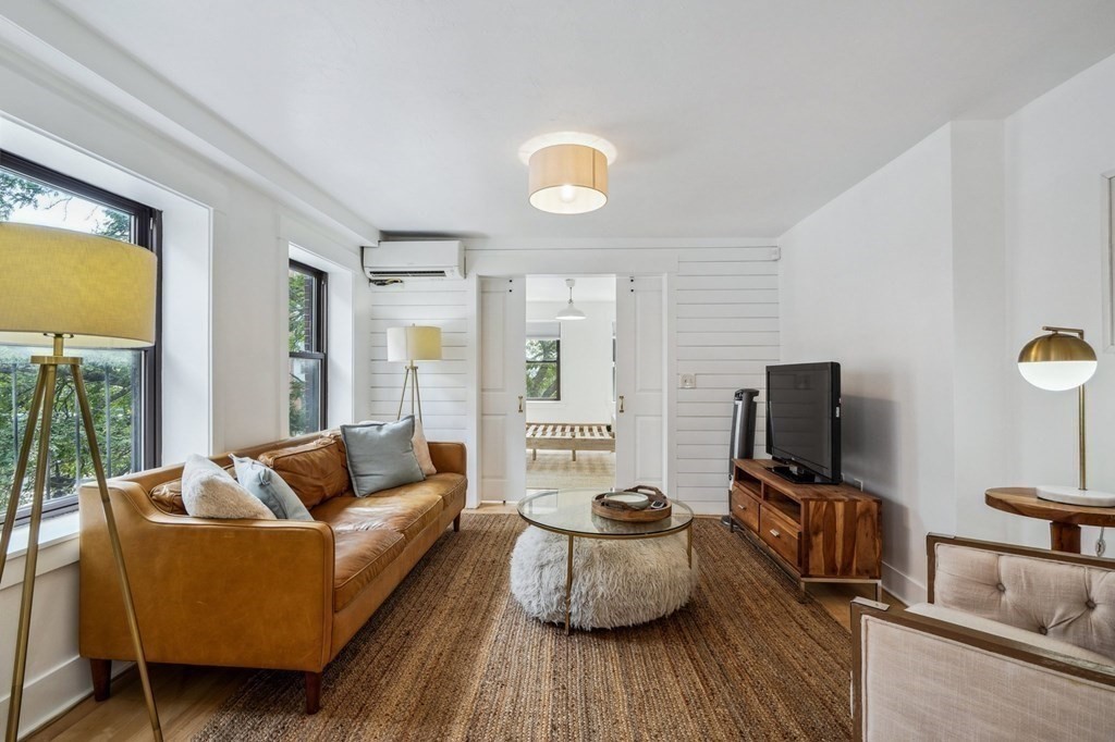 59 Fleet Street, Unit 3 Boston, MA 02109 - Photo 5 of 24 a living room with furniture and a flat screen tv