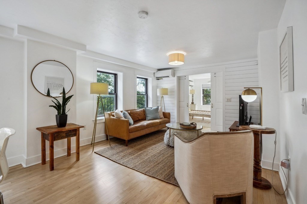59 Fleet Street, Unit 3 Boston, MA 02109 - Photo 6 of 24 a living room with furniture a bathtub and a chandelier