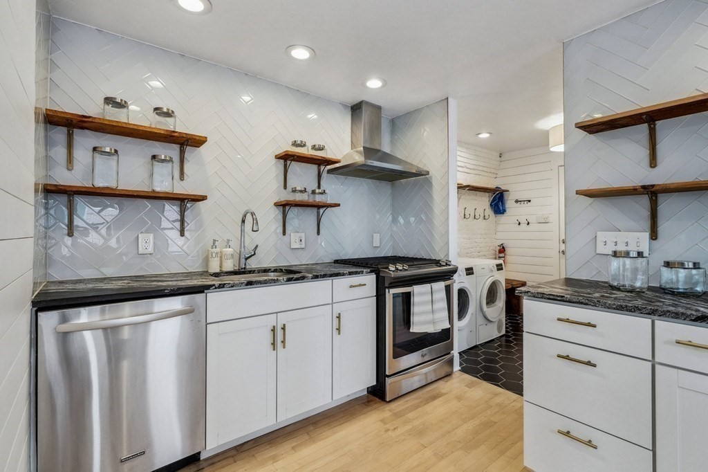 59 Fleet Street, Unit 3 Boston, MA 02109 - Photo 8 of 24 a kitchen with stainless steel appliances granite countertop a sink and cabinets