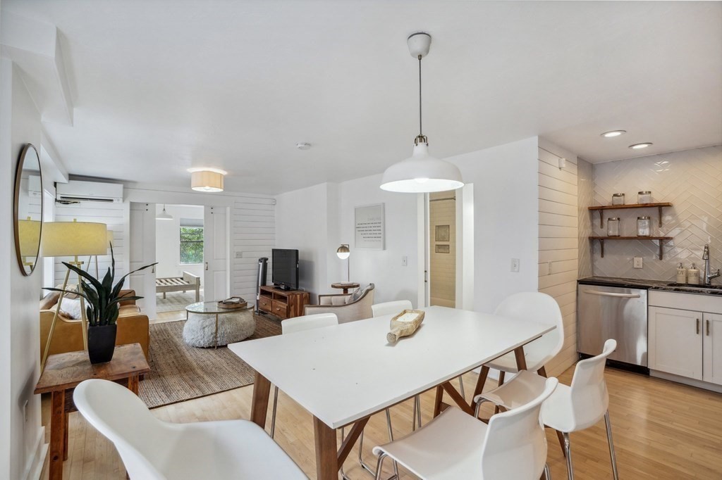 59 Fleet Street, Unit 3 Boston, MA 02109 - Photo 9 of 24 a view of a dining room and livingroom with furniture wooden floor a chandelier