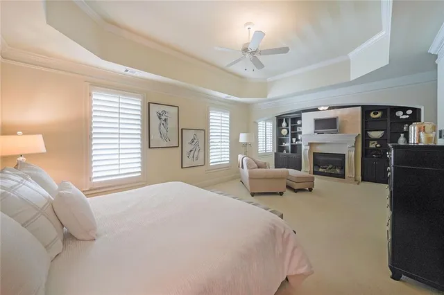 a bedroom with bed couch and window