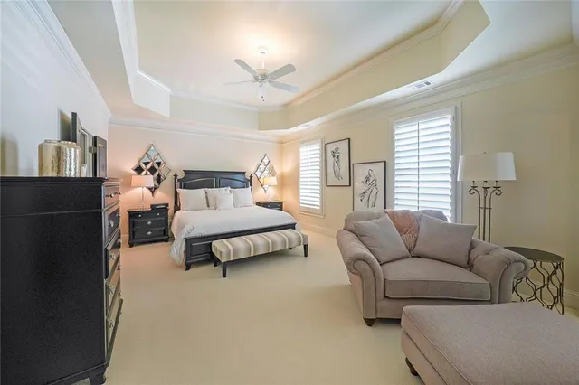 a living room with stainless steel appliances furniture a fireplace and a flat screen tv