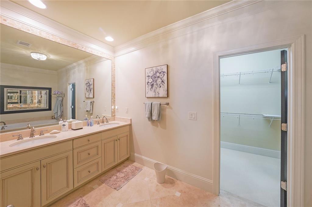 9062 Riverbend Manor Alpharetta, GA 30022 - Photo 22 of 36 a spacious bathroom with a double vanity sink a mirror and shower