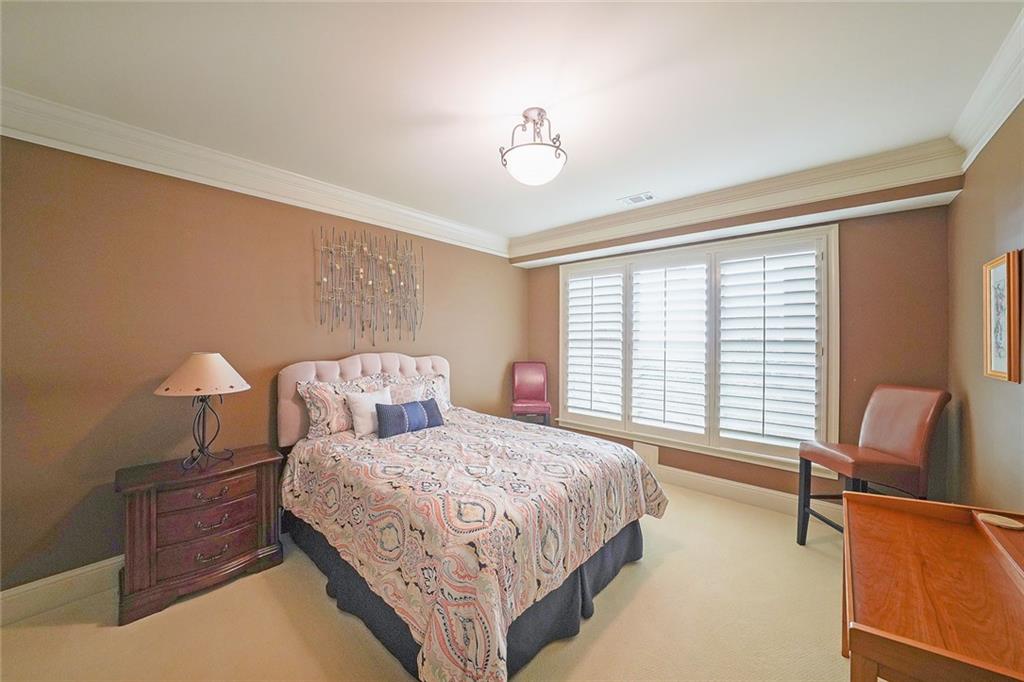 9062 Riverbend Manor Alpharetta, GA 30022 - Photo 29 of 36 a bedroom with a bed and a chandelier