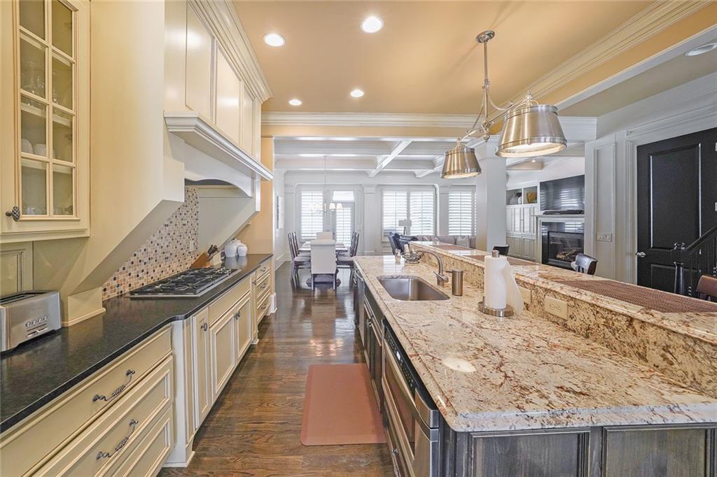 9062 Riverbend Manor Alpharetta, GA 30022 - Photo 9 of 36 a large kitchen with kitchen island a stove a sink a counter space and dining table