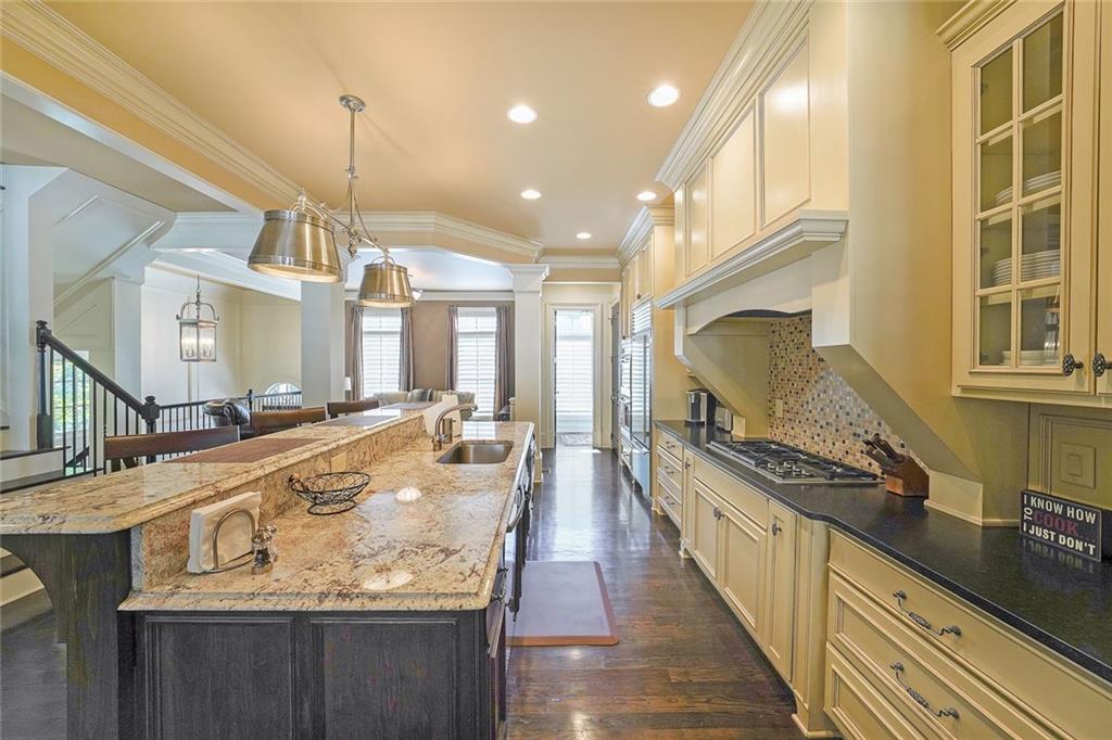9062 Riverbend Manor Alpharetta, GA 30022 - Photo 10 of 36 a large kitchen with kitchen island a large counter top space a sink stainless steel appliances and cabinets