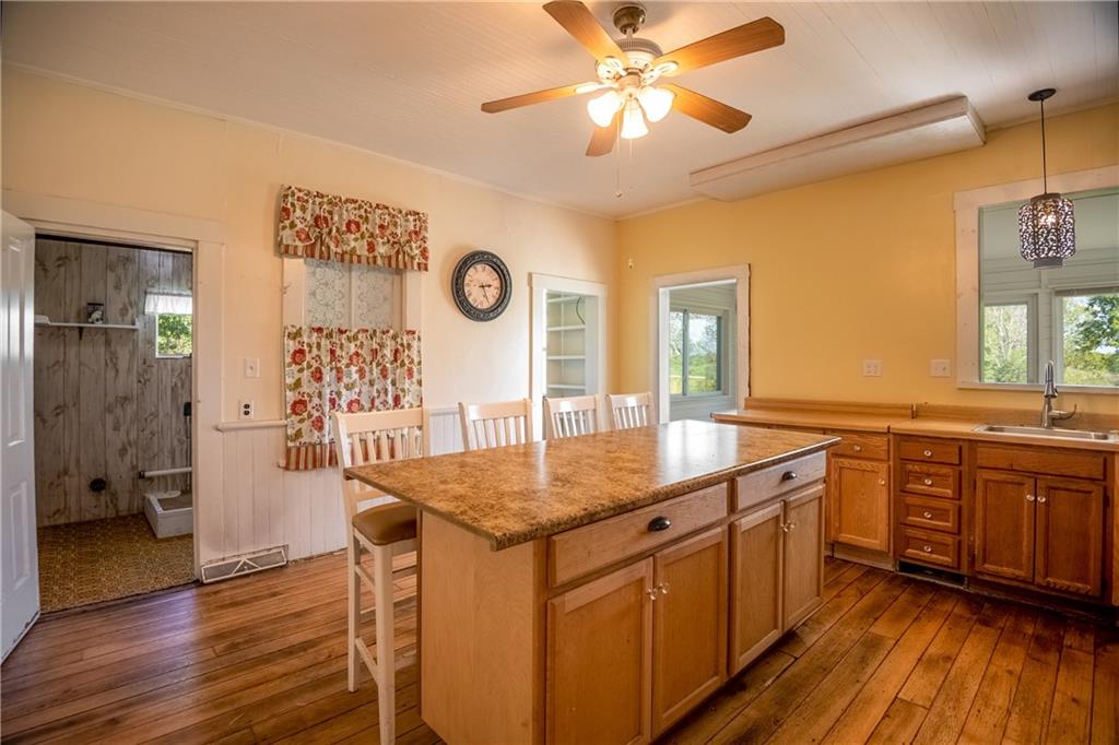 2042 Plain Grove Road Volant, PA 16156 - Photo 10 of 23 a kitchen with a table chairs and wooden floor
