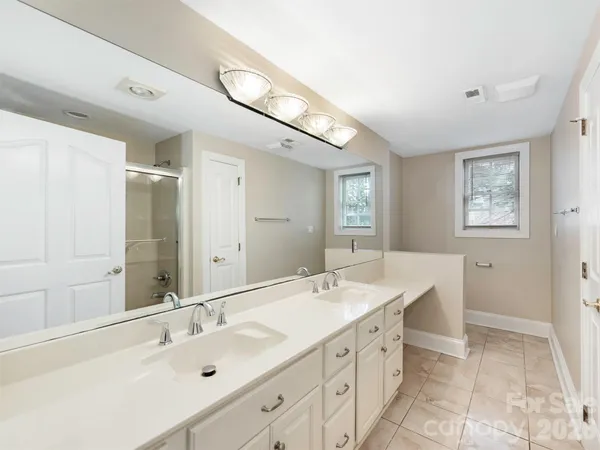 a spacious bathroom with a double vanity sink mirror and