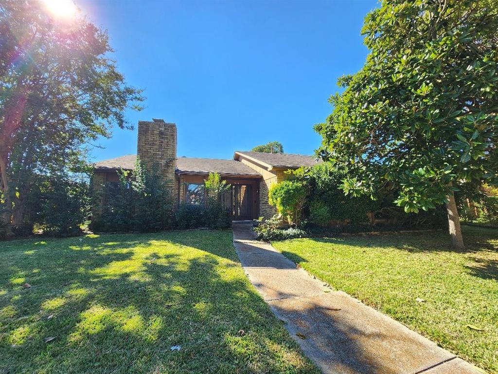 3114 Nutmeg Lane Garland, TX 75044 - Photo 1 of 18 a view of a patio with a table and chairs under an umbrella
